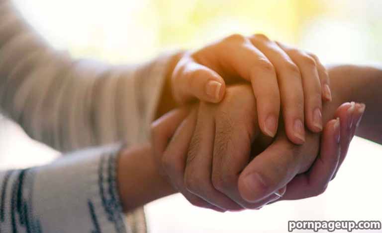 Adult Sex: Understanding Boundaries in Healthy Adult Relationships Two people holding hands in a comforting, supportive gesture.